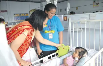  ?? Photo: ?? Minister for Health and Medical Services Rosy Akbar visiting one of the patients at the Colonial War Memorial Hospital Children’s Ward on December 9, 2017.