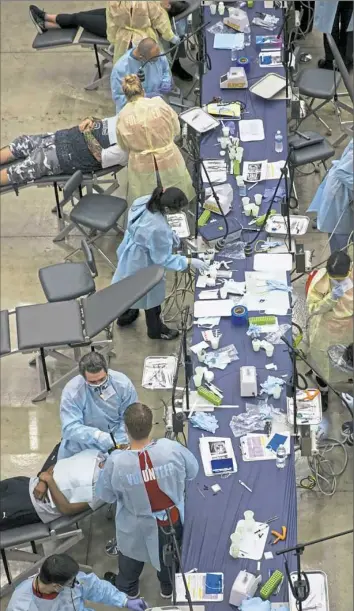  ?? Alex Driehaus/Post-Gazette ?? Patients receive treatment during the Mission of Mercy Pittsburgh free dental clinic.