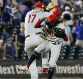  ?? FRANK FRANKLIN II — THE ASSOCIATED PRESS ?? The Phillies’ Rhys Hoskins (17) and Roman Quinn (24) celebrate after the team’swin over the Mets on Friday in New York.