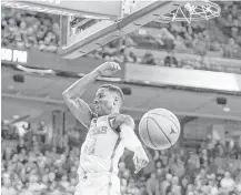  ?? Nick Wagner / Austin American-Statesman ?? Texas guard Kerwin Roach dunks against Texas Tech, making a splashy return to the lineup Wednesday after sitting out with a fractured left hand. UT upset Texas Tech at the Erwin Center.