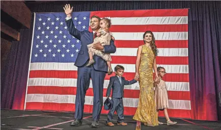  ?? GIORGIO VIERA/AFP VIA GETTY IMAGES ?? Republican Florida Gov. Ron DeSantis joins his wife, Casey, and their children at an election night watch party in Tampa on Tuesday. He may have ambitions for a higher office in 2024.