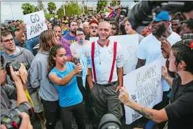  ?? WILL VRAGOVIC/TAMPA BAY TIMES VIA AP ?? Protesters confront a man wearing a shirt with swastikas outside a University of Florida auditorium where white nationalis­t Richard Spencer was preparing to speak Thursday in Gainesvill­e, Fla.