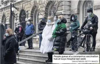  ?? DAN KITWOOD /GETTY IMAGES ?? People queue at a coronaviru­s vaccinatio­n hub at Guys Hospital last week