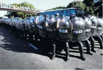  ??  ?? Tough response . . . Riot police stand guard after clashes with protesters during a rally in support of President Nicolas Maduro outside the University of Buenos Aires’ Law School, in Argentina, yesterday.