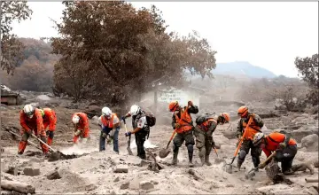  ??  ?? Rescue workers search the house of Garcia’s missing sisters.