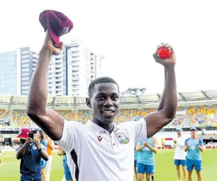  ?? AP ?? West Indies fast bowler Shamar Joseph raises the ball after taking seven wickets in his team’s eight-run win over Australia on the fourth day of the second Test in Brisbane, Sunday, January 28, 2024.