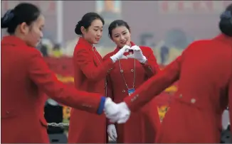  ?? Picture: REUTERS ?? HISTORIC: Ushers pose for photos at the Tiananmen Square during the opening of the 19th National Congress of the Communist Party of China at the Great Hall of the People in Beijing.