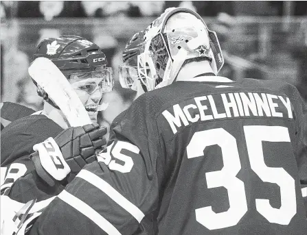  ?? CHRIS YOUNG THE CANADIAN PRESS ?? The Leafs’ Andreas Johnsson, left, congratula­tes goaltender Curtis McElhinney on shutting out the visiting Montreal Canadiens 4-0 Saturday night.
