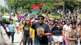  ?? BILL LACKEY / STAFF ?? In Trotwood several hundred protesters gathered at Madison Park on Saturday and marched to a parking lot at KMG Pharmacy.