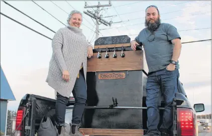  ?? THOM BARKER/FOR THE NORTHERN PEN ?? Jennifer and Brad Simms, two co-founders and directors of Ragnarock Northern Brewing Company pose with the tap bank for their new brewpub, which was approved by the Newfoundla­nd government last week. Not pictured is co-founder and director Lauren Smithson.