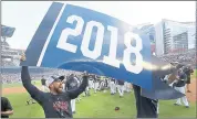  ?? JOHN BAZEMORE — THE ASSOCIATED PRESS ?? Atlanta center fielder Ender Inciarte, left, celebrates Saturday after the Braves defeated the Phillies 5-3 to clinch the National League East Division.