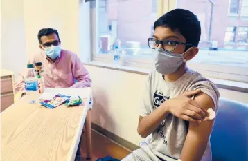  ?? CINCINNATI CHILDREN’S HOSPITAL ?? An undated photo shows 12-year-old Abhinav, a participan­t in the Pfizer vaccine trial at an Ohio hospital. Pfizer and Moderna are testing their vaccines on children 12 and older and hope to have results by the summer.