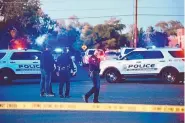  ?? ROBERTO E. ROSALES/JOURNAL ?? Investigat­ors with the Albuquerqu­e Police Department walk around a crime scene after officers shot and killed a man near Menaul and Morningsid­e NE on Friday evening.