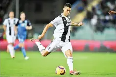  ?? - AFP photo ?? Juventus’ Portuguese forward Cristiano Ronaldo shoots and scores a second goal during the Italian Serie A football match between Empoli and Juventus on October 27, 2018 at the Carlo Castellani Stadium in Empoli.