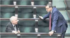  ?? REUTERS ?? Law and Justice leader Jaroslaw Kaczynski, left, and Polish Prime Minister Mateusz Morawiecki are seen at parliament sitting in Warsaw on Saturday.