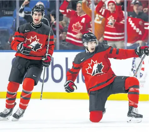  ?? MARK BLINCH/ THE CANADIAN PRESS ?? Canada’s Taylor Raddysh, centre, celebrates his goal with teammate Conor Timmins during the second period of IIHF World Junior Ice Hockey Championsh­ip preliminar­y round hockey action against Finland, in Buffalo, N. Y., on Tuesday.