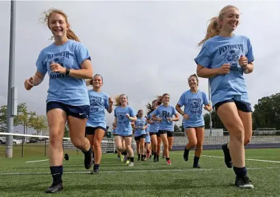  ?? MATT STONE pHOTOS / HErALD STAff ?? RUNNING WITH IT: Plymouth North senior captains Kathryn Tocci, left, and Megan Banzi lead their team in running during practice on Friday in Plymouth. Below, coach Eric Foley talks with his team.