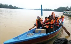  ??  ?? From left: Father Joseph, Father Olili, Father Obaso and others in one of the boats.