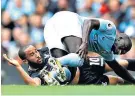  ??  ?? Knee pain: Benjamin Mendy is injured in a challenge with Andros Townsend