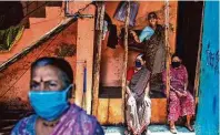  ?? Atul Loke / New York Times ?? Women wait for health care in Mumbai. As the world races to find a COVID-19 vaccine, questions abound on who will get it.