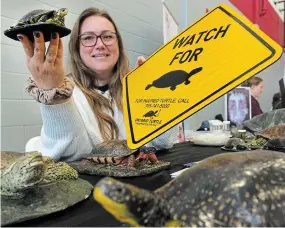  ?? CLIFFORD SKARSTEDT PETERBOROU­GH EXAMINER PHOTOS ?? Isa Prophet of the Ontario Turtle Conservati­on Centre sets up her booth during the inaugural Meet Your Match Volunteer Fair.