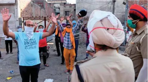  ??  ?? Police officers punish violators during a government-imposed nationwide lockdown as a preventive measure against the spread of the Covid-19 in Amritsar yesterday.