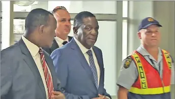  ?? AP PHOTO ?? In this photo taken from video, Zimbabwe’s incoming leader Emmerson Mnangagwa, centre, walks into an airport to board a flight bound for Zimbabwe, at Lanseria Airport, northwest of Johannesbu­rg, South Africa yesterday.