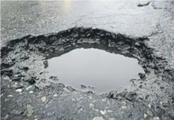  ??  ?? Potholes and damaged road surfaces like these are a major concern for road users