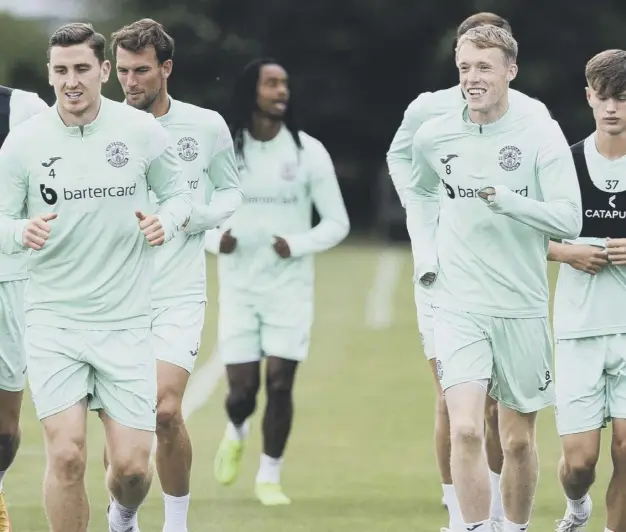  ?? ?? Hibs players in training for this afternoon’s cinch Premiershi­p clash against Rangers. Manager Lee Johnson, inset, has organised for a sniper to speak to the squad in the next couple of weeks to help with their concentrat­ion levels
