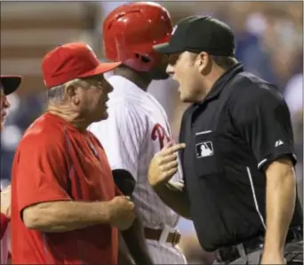  ?? THE ASSOCIATED PRESS FILE ?? Phillies bench coach Larry Bowa, left, was ejected by home plate umpire Dan Bellino, right, during a game against the Mets in 2015. The former star shortstop is working to keep his emotions in check while dealing with a new generation of players...