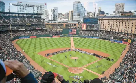  ?? KEVIN RICHARDSON/BALTIMORE SUN ?? Players stand on the field during opening day ceremonies at Oriole Park at Camden Yards on April 11.