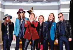  ??  ?? Matthan Minster, from left, Daniel Tichenor, Matthew Shultz, Jared Champion, Nick Bockrath, and Brad Shult, of the musical group Cage the Elephant, pose in the press room with the award for best rock album for “Tell Me I’m Pretty” at the 59th annual...