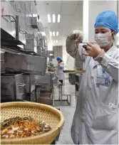  ??  ?? A pharmacist compounds traditiona­l Chinese medicine at The First Affiliated Hospital of Anhui University of Chinese Medicine in Hefei.