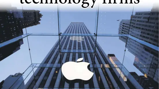  ??  ?? The Apple corporate logo hangs in the iconic glass box entrance to the company's Fifth Avenue store, New York, Sept. 5, 2014.