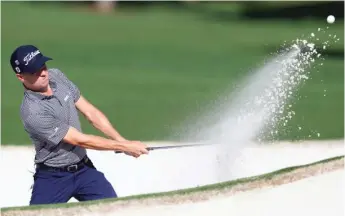  ?? AP (ABOVE), GETTY IMAGES ?? Justin Thomas (above, hitting out of a bunker on the seventh hole) shot a 69. Dustin Johnson (playing a shot on the eighth hole) had a 70.