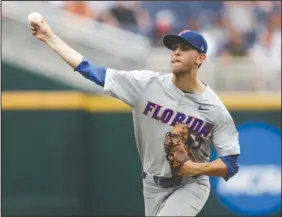  ?? The Associated Press ?? JACKSON K: Florida pitcher Jackson Kowar (37) delivers against Texas in the fourth inning of the Gators’ 6-1 win Tuesday to eliminate the Longhorns from the College World Series in Omaha, Neb. Kowar set a career high in strikeouts with 13 in 6 2/3 innings.