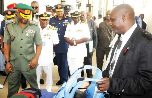  ??  ?? From left: Chief of Defence Staff, Gen. Abayomi Olonisakin; Chief of Naval Staff, Vice Adm. Ibok Ibas, and Chief of Air Staff, Air Marshal Sadique Abubakar, at an exhibition stand, during the 2015 Nigerian Navy Research and Developmen­t Seminar, in...