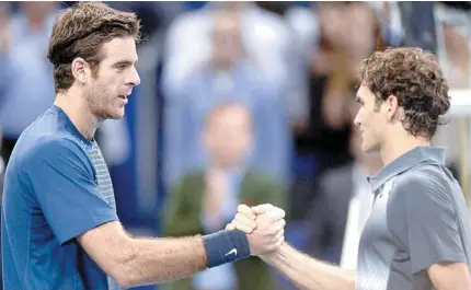  ?? match in Basel. AFP PHOTO ?? Switzerlan­d’s Roger Federer ( right) congratula­tes Argentina’s Juan Martin Del Potro after he won the Swiss Indoors ATP tennis tournament finals