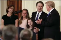  ?? PHOTO/EVAN VUCCI ?? President Donald Trump greets Judge Brett Kavanaugh his Supreme Court nominee, in the East Room of the White House on Monday in Washington. AP