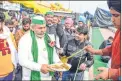  ??  ?? BKU leader Rakesh Tikait having a meal on Makar Sankranti during farmers' protest against in New Delhi.