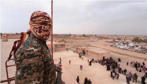  ?? (Rodi Said/Reuters) ?? A SYRIAN DEMOCRATIC Forces (SDF) fighter overlooks people fleeing areas surroundin­g the Euphrates River dam, east of Raqqa city, Syria, last week. The author writes that the US policy in Syria is harmful for Israel.