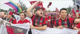  ?? STEPHEN M. DOWELL / ORLANDO SENTINEL ?? Atlanta fans show their enthusiasm outside the stadium before the start of last week’s match vs. Orlando City in Orlando.