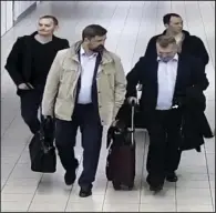  ?? AP/Dutch Defense Ministry ?? Four Russian military intelligen­ce agency officers head for a flight out of the Netherland­s on Oct. 4 after they were expelled for trying to hack into the computers of the Organizati­on for the Prohibitio­n of Chemical Weapons. The case is among several cited Thursday in indictment­s by U.S., British, Australian and Dutch officials.