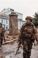  ?? Evgeniy Maloletka/Associated Press ?? Ukrainian servicemen who recently returned from the trenches of Bakhmut walk on a street in Chasiv Yar, Ukraine, Wednesday.