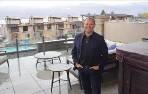  ?? BARB AGUIAR/Westside Weekly ?? Ken Nichols, president of Gasland Properties and Paradise Estates developer, on the rooftop garden that has a hot tub and a view of the lake and 50-foot pool.