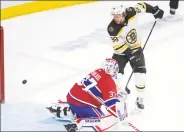  ?? Ryan Remiorz / Associated Press ?? Boston Bruins right wing David Pastrnak scores his third goal of the game past Montreal Canadiens goaltender Keith Kinkaid on Tuesday.