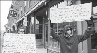  ?? NICKI KOHL / TELEGRAPH HERALD VIA AP ?? Lois Pence, left, and Regina Hutchison gather with other protesters on Nov. 14 outside the office of U.S. Rep. Rod Blum R-iowa, in Dubuque, Iowa, to oppose the Republican tax plan. Residents in Cedar Rapids and Waterloo, Iowa, also gathered at the same...