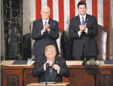  ?? Pablo Martinez Monsivais / Associated Press ?? President Trump pauses to take a sip of water during his address to a joint session of Congress on Tuesday as Vice President Mike Pence (left) and House Speaker Paul Ryan, R-Wis., applaud.