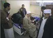  ?? AMR NABIL — ASSOCIATED PRESS ?? Relatives surround Sheikh Sulieman Ghanem, 75, center, as he receives treatment Friday. Ghanem was injured during an attack on a Sinai Peninsula mosque Friday.