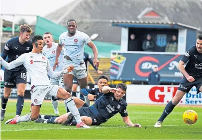  ?? Pictures: SNS. ?? Top: Andy Dales comes close to scoring for the Dark Blues; above: Dundee defenders Nathan Ralph, Darren O’dea and Ryan Mcgowan can only look on as Sean Clare stabs home Hearts’ winner.